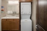 Stacked washer and dryer with complimentary laundry supplies